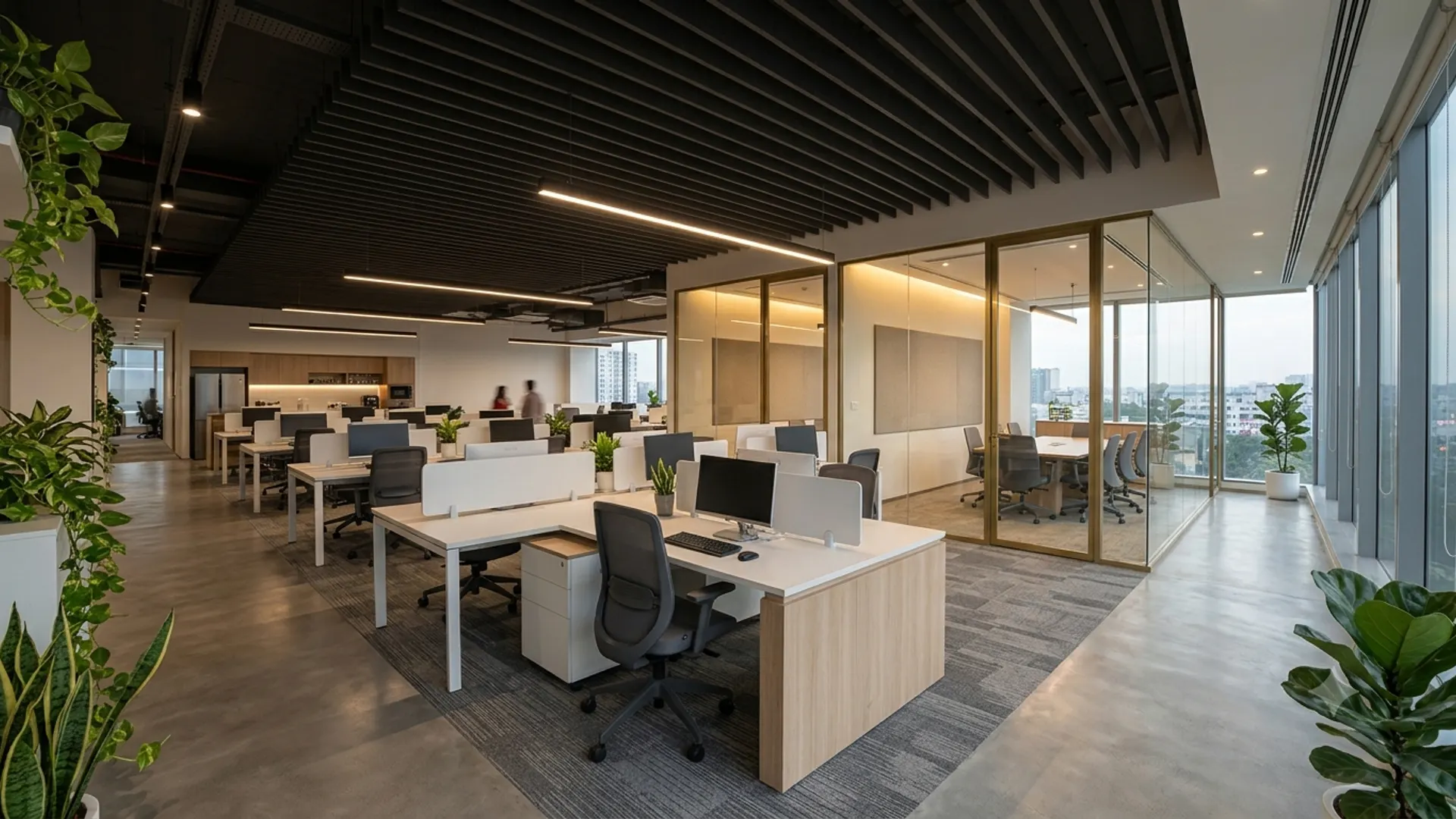 Modern open-plan office interior with workstations and warm lighting